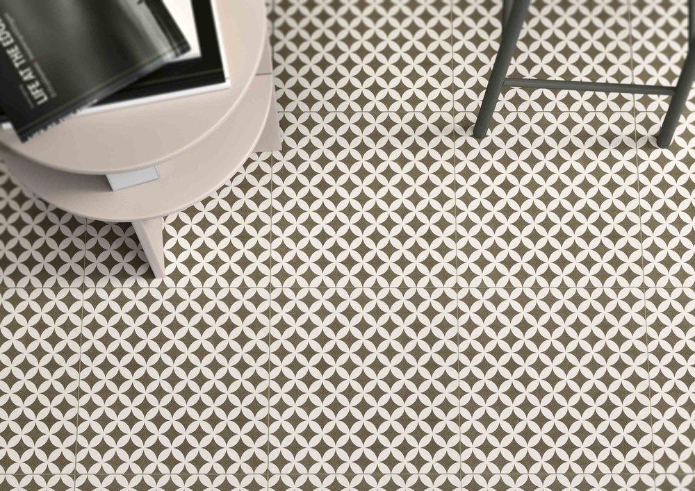 Beige geo porcelain tile on the floor with table and chair legs in view.