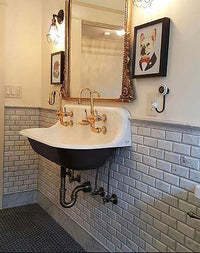 Elegant bathroom sink basin and mirror against beveled marble brick tile